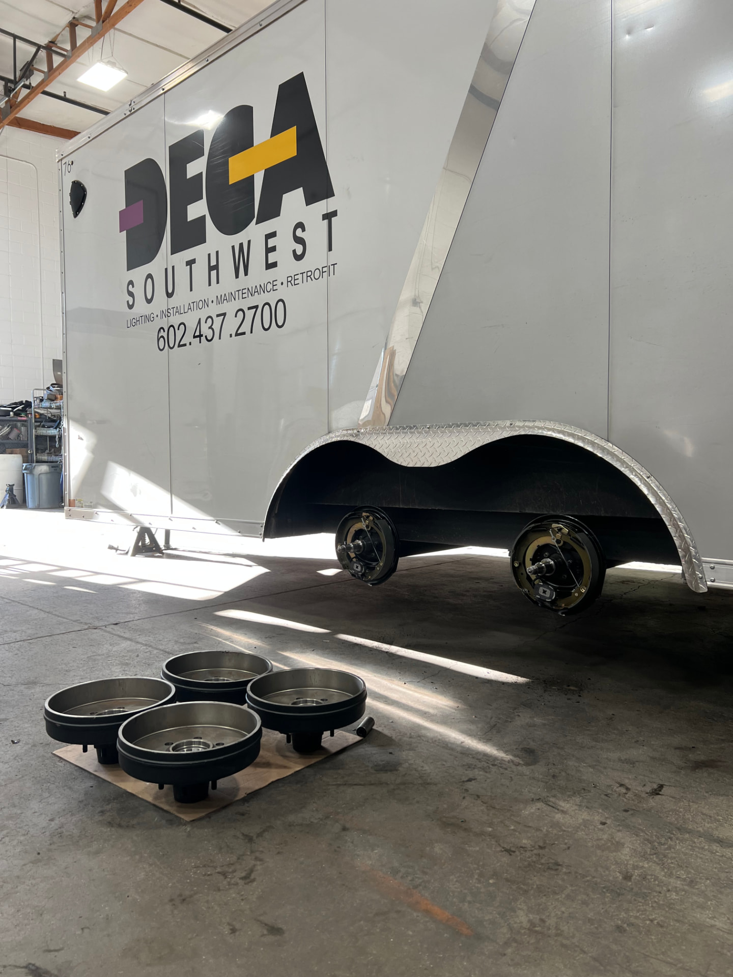 DECA Southwest enclosed trailer with new brake assemblies and drums in the SPARKS Trailer Repair shop